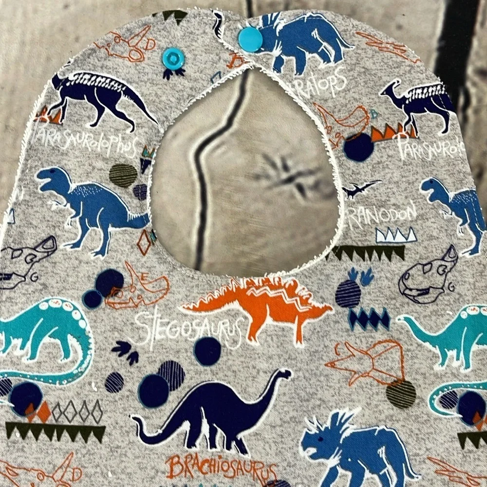 Designer handcrafted dinosaur bib
